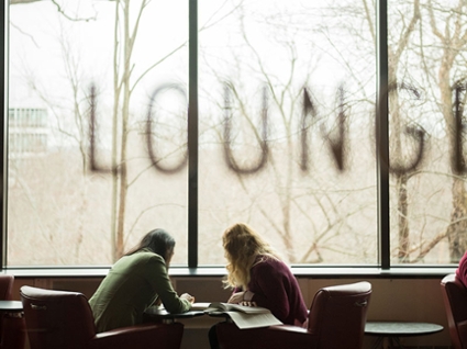 Candid shot of Heller students studying in the Alumni Lounge