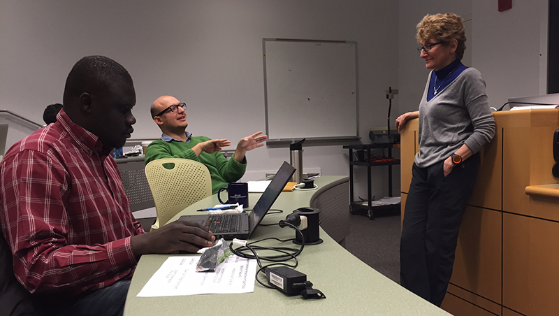 Professor Joan Dassin talks with students in class