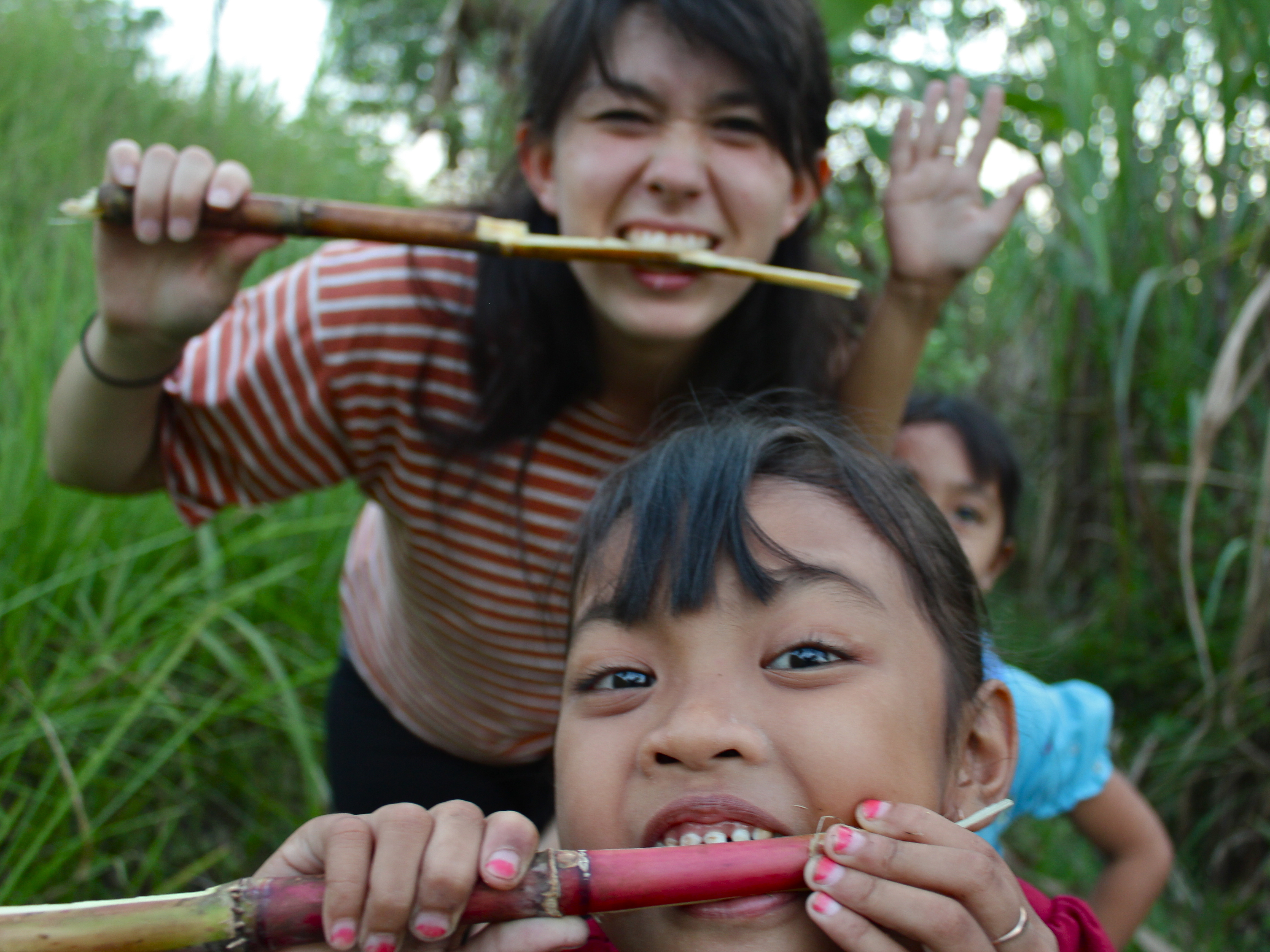 A woman and a child gnawing sugarcane