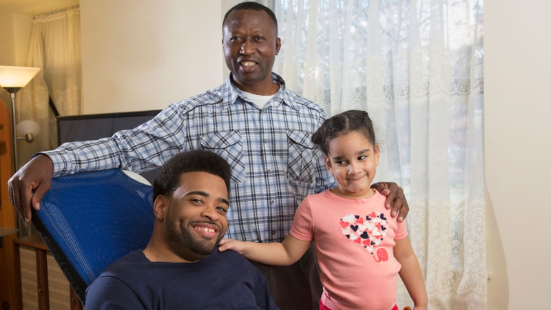 Two men at home with child