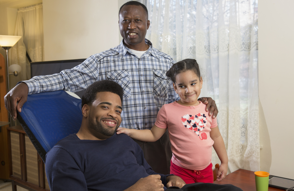 Two men at home with child