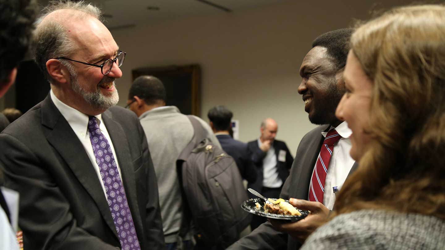 Dean Weil talking to a student