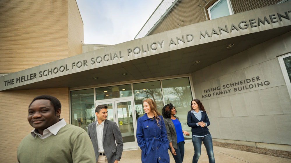 Heller students walking outside Schneider Building.