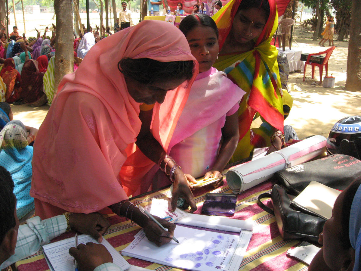 At a meeting of Mahila Swasthya Adhikar Manch (MSAM), or Women's Health Rights Forum in English, women line up to sign their names and add their fingerprints to a petition for local government officials demanding improved access to local health care 