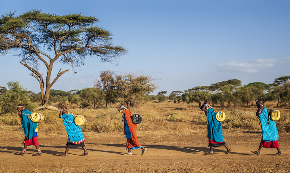 African women from Maasai tribe carrying water
