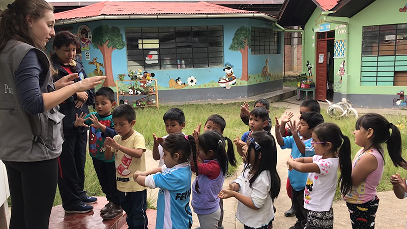 Nicole Levesque teaching hand-washing to a group of elementary school children in Peru