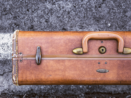 A leather briefcase sitting on the ground