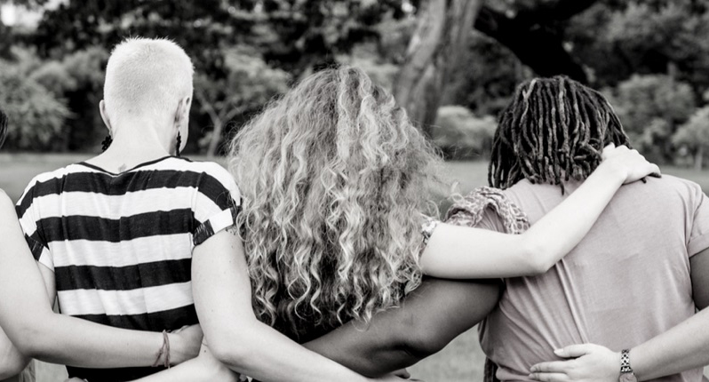 Women walking with their arms around each other