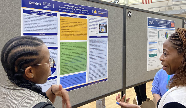 Researcher Shanesha Christmas (right) discusses preliminary findings at the 2024 Boston Addiction Conference