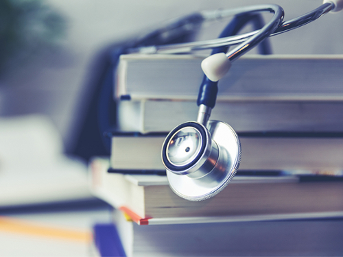 Image of a stethoscope on top of a stack of books