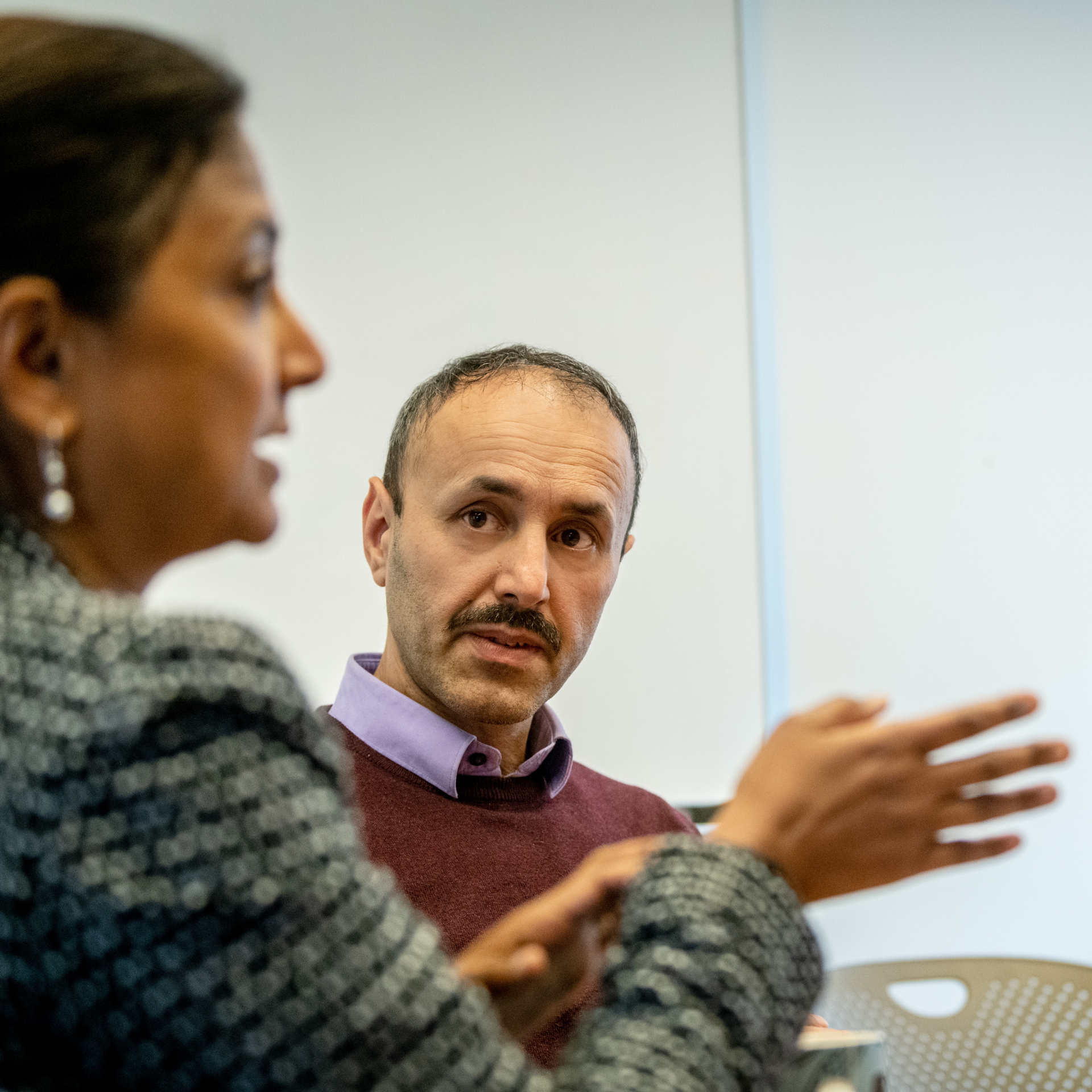 A Lurie Institute employee is looking at the Lurie Institute director in a meeting