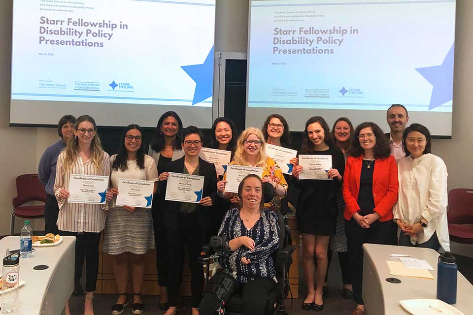 A group of undergraduate fellows & research mentors are pictured in front of a screen that reads "Starr Fellows in Disability Policy Research Presentation