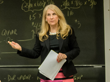 Brenda Anderson standing in front of blackboard in classroom