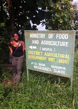 Photo of Melanie Allen standing next to a sign that says Ministry of Food and Agriculture