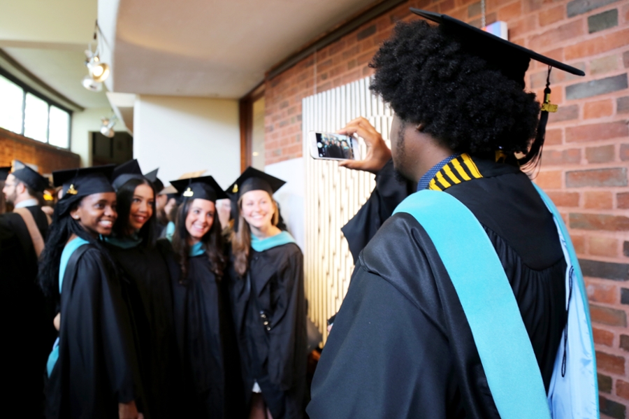 Students taking photos at Heller commencement.