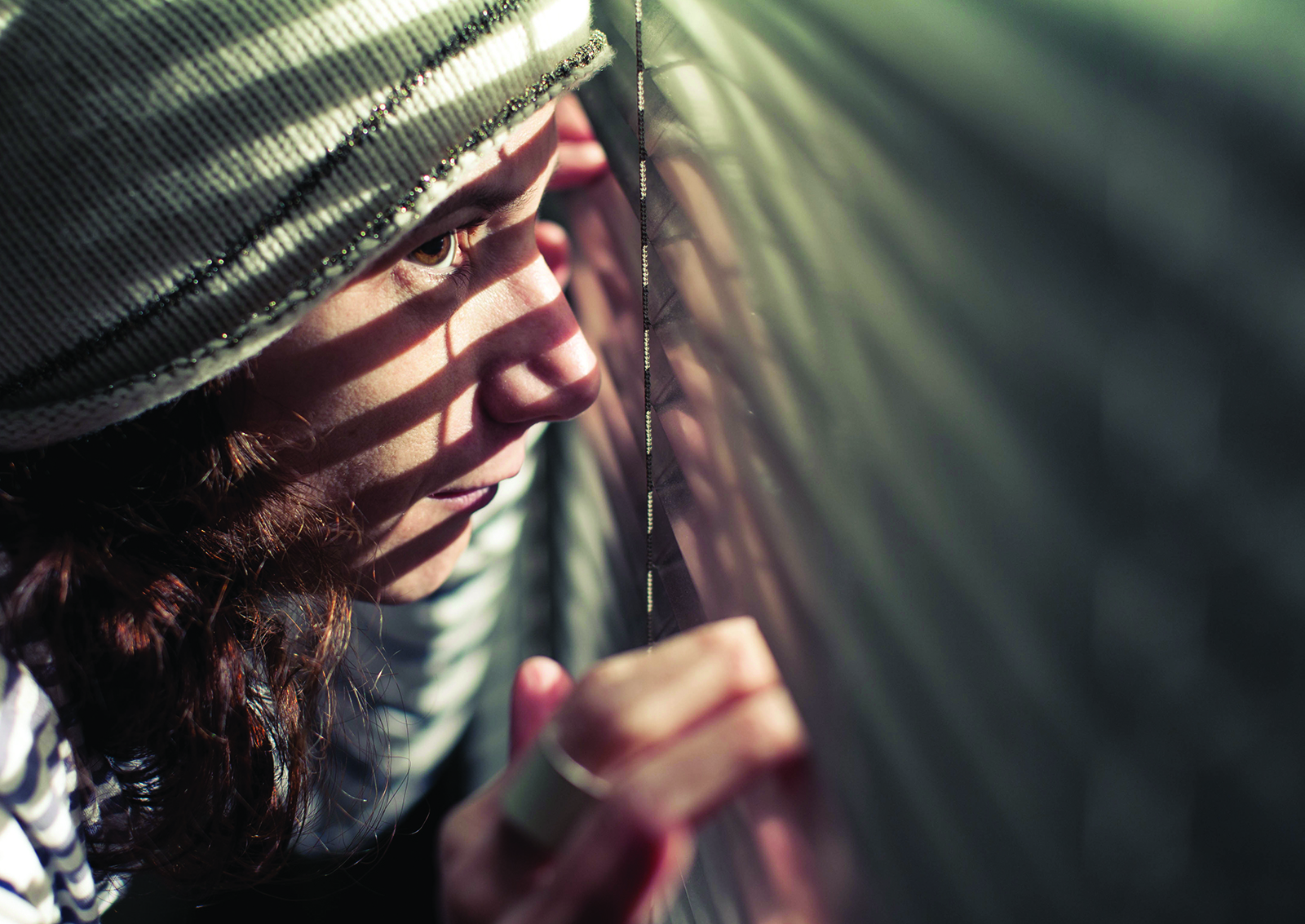 image of young person looking out a window