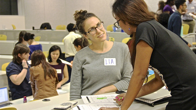 students working and talking together at startup challenge