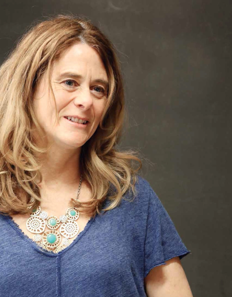 image of Susan Eaton in front of a classroom blackboard