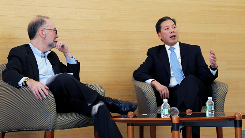 Dean Weil and Chris Lu talking on stage