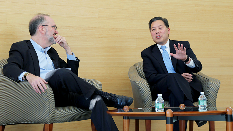 Dean Weil and Chris Lu talking on stage