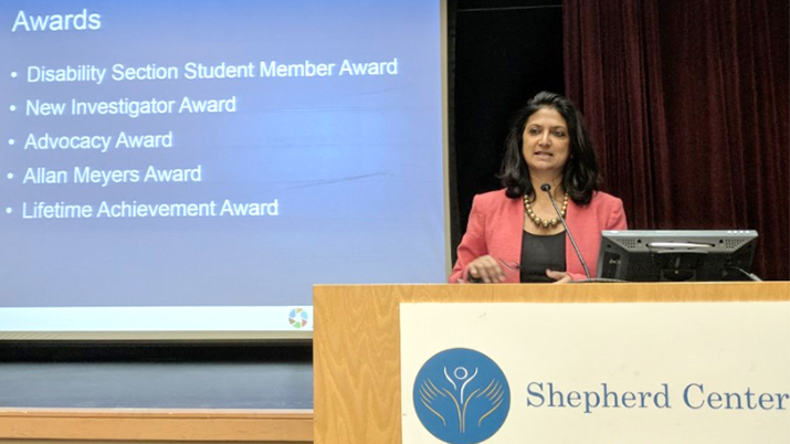 Monika Mitra gives remarks at APHA when presented with her award