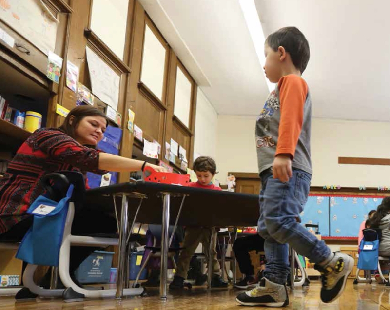 image of preschool kids and teacher in classroom