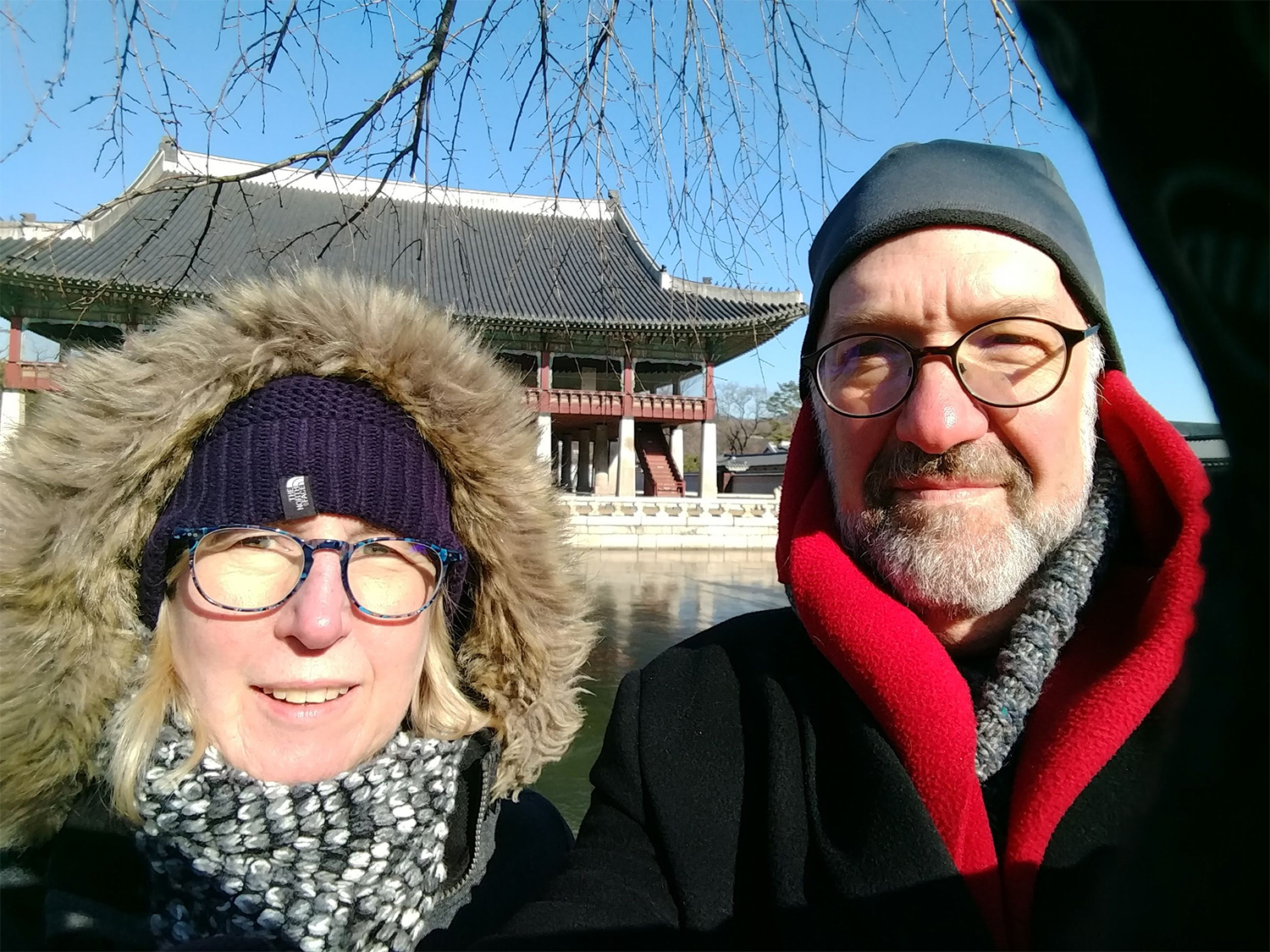 Dean Weil and Miriam in front of a historic building in Korea