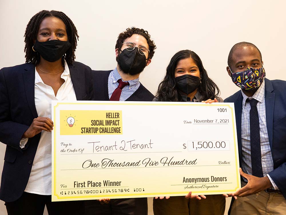 Four students pose with a check for the Tenant2Tenant team