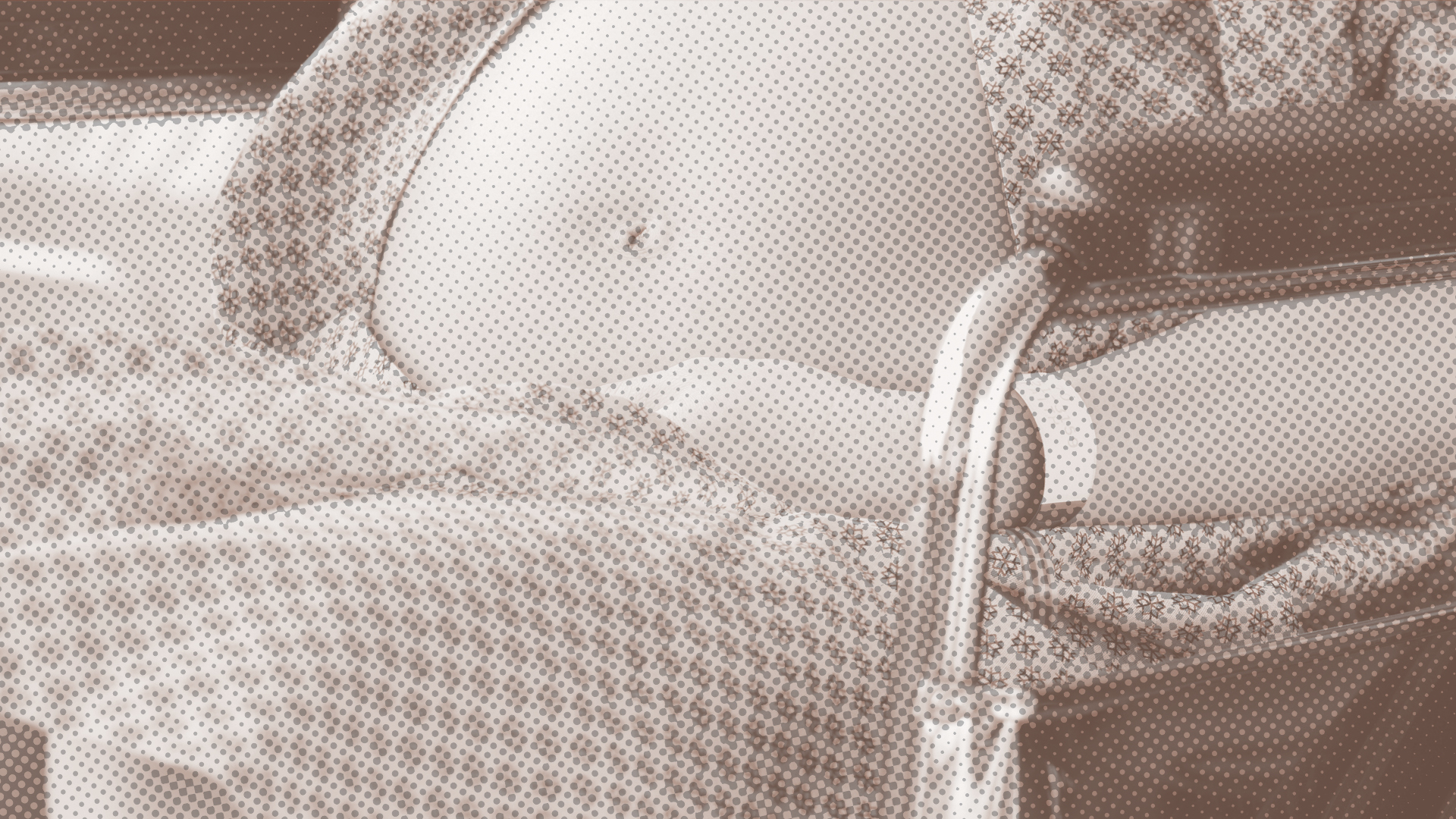 A close-up of a stomach of a pregnant person in a wheelchair, with a brown filter