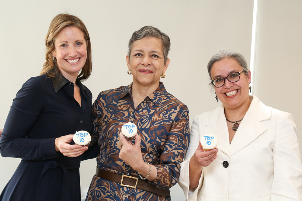 Heller Award winners Kate Giapponi Schneider, PhD'16 (left) and Alexandra Piñeros-Shields, PhD'07 (right) flank Dolores Acevedo-Garcia at the 2024 Heller Awards ceremony