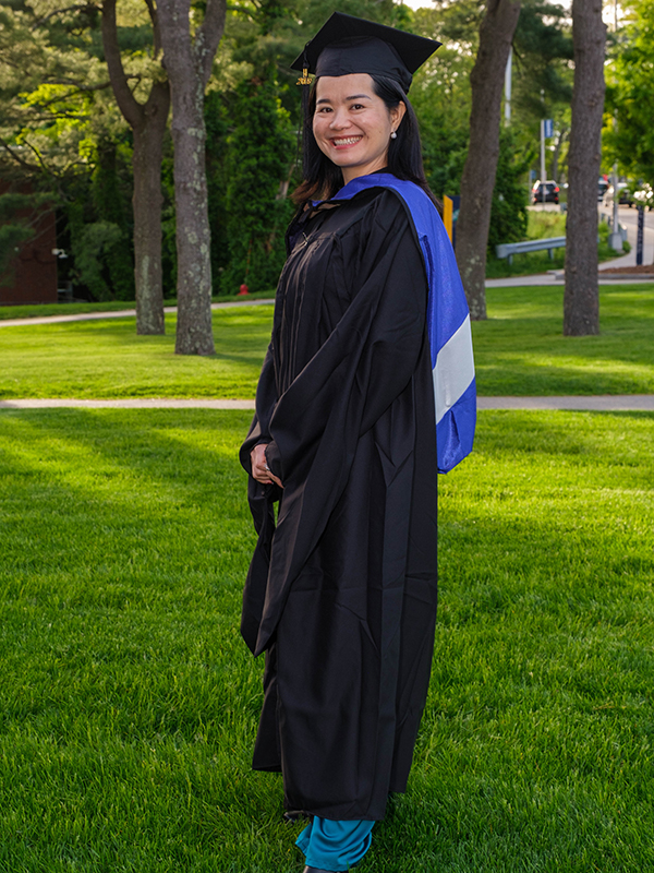 Thuong Nong, PhD'24, in graduation cap and gown