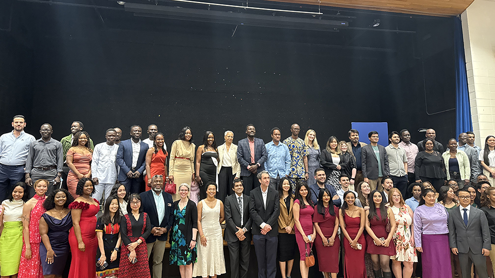 Heller 2025 graduates pose with Interim Dean Maria Madison