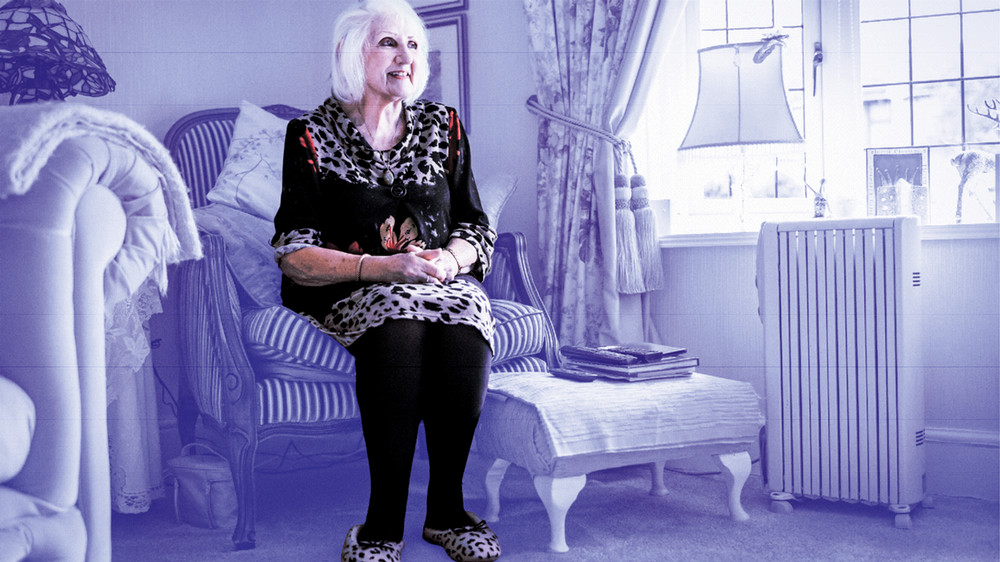 Photo of older woman sitting in chair and smiling