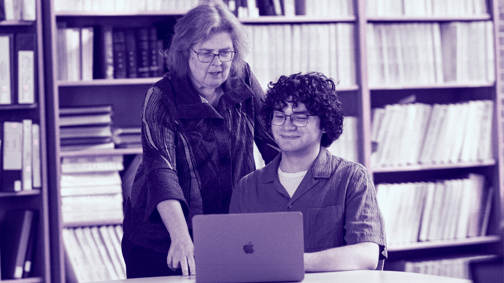 Professor Karen Donelan and student look at laptop screen
