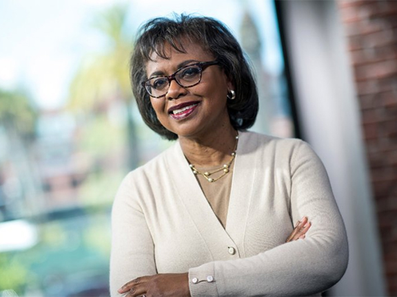 Anita Hill standing and wearing white