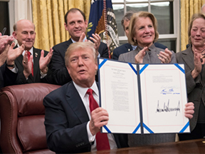 Donald Trump showing a document he signed