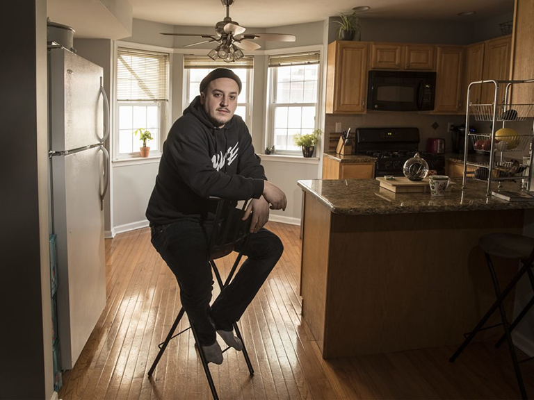 A man sitting in his kitchen