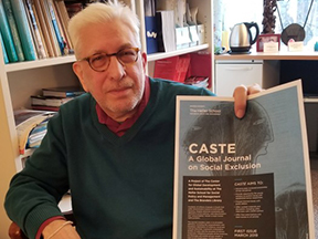 Larry Simon holding a flier for J-CASTE