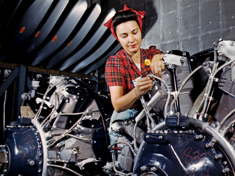 1950s woman working on a motorcycle