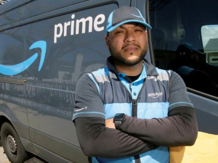 Man in front of amazon delivery truck