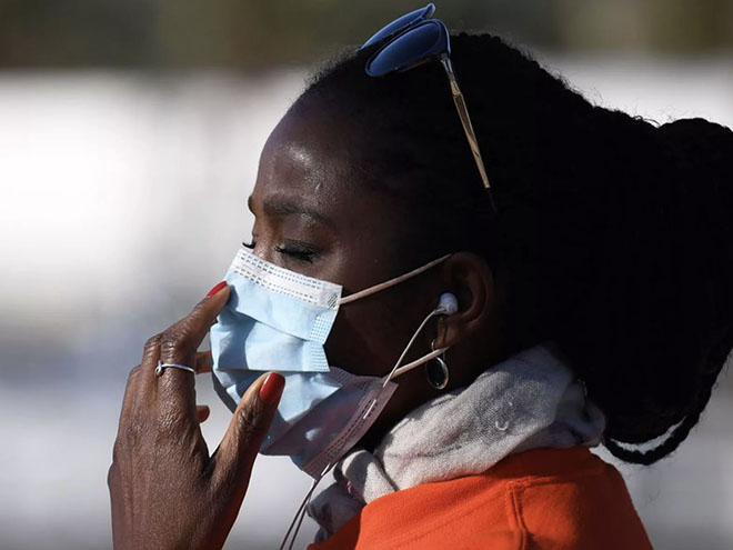 A black woman with a surgical mask