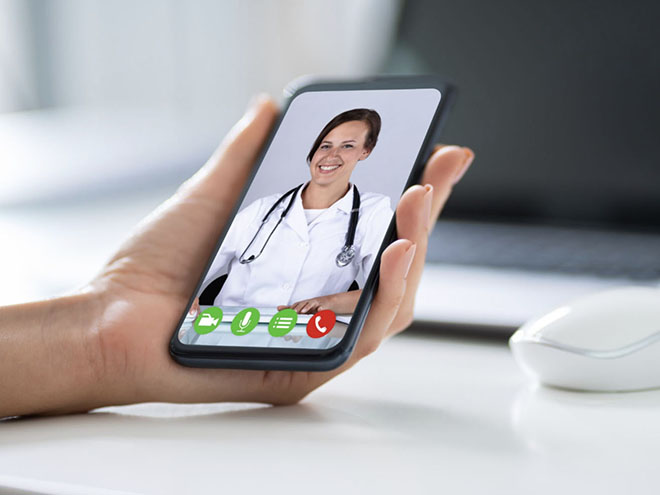 hand holding smartphone with doctor's image