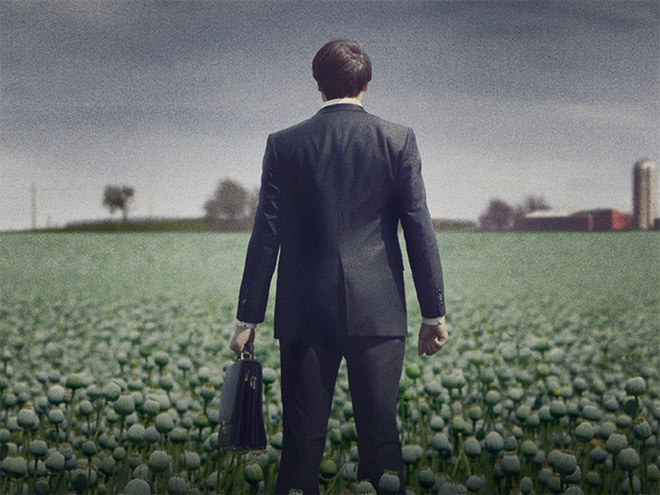 Illustration of the back of a man in a suit carrying a briefcase in a field full of poppies