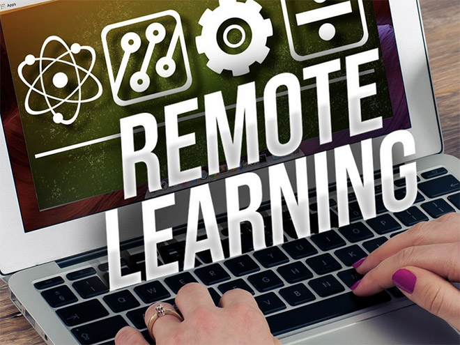 A laptop with the words Remote Learning and various symbols 