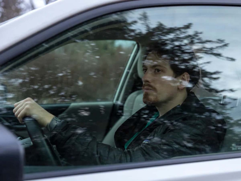 A man behind the wheel of a car
