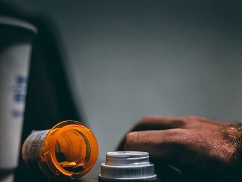 Open bottle of pills on a table