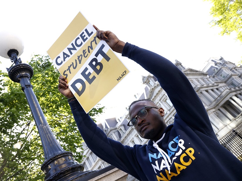 Man holding sign that reads "Cancel Student Debt"