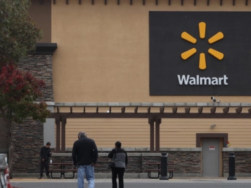 Exterior of a Walmart with people walking towards it