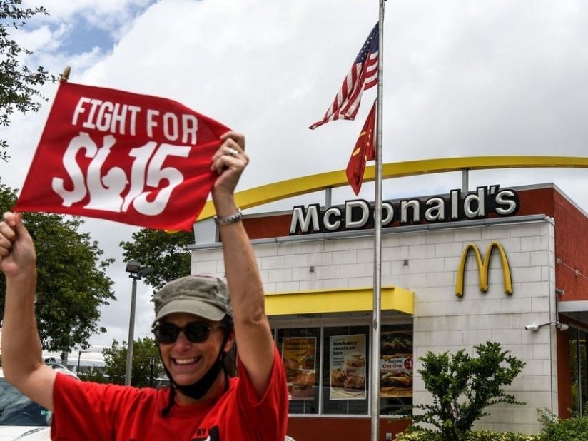An employee of McDonald's protests outside a branch restaurant for a raise in their minimum wage to $15 an hour, in Fort Lauderdale, Florida, on May 19, 2021