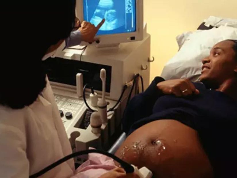 A woman getting an ultrasonography to see the status of her pregnancy